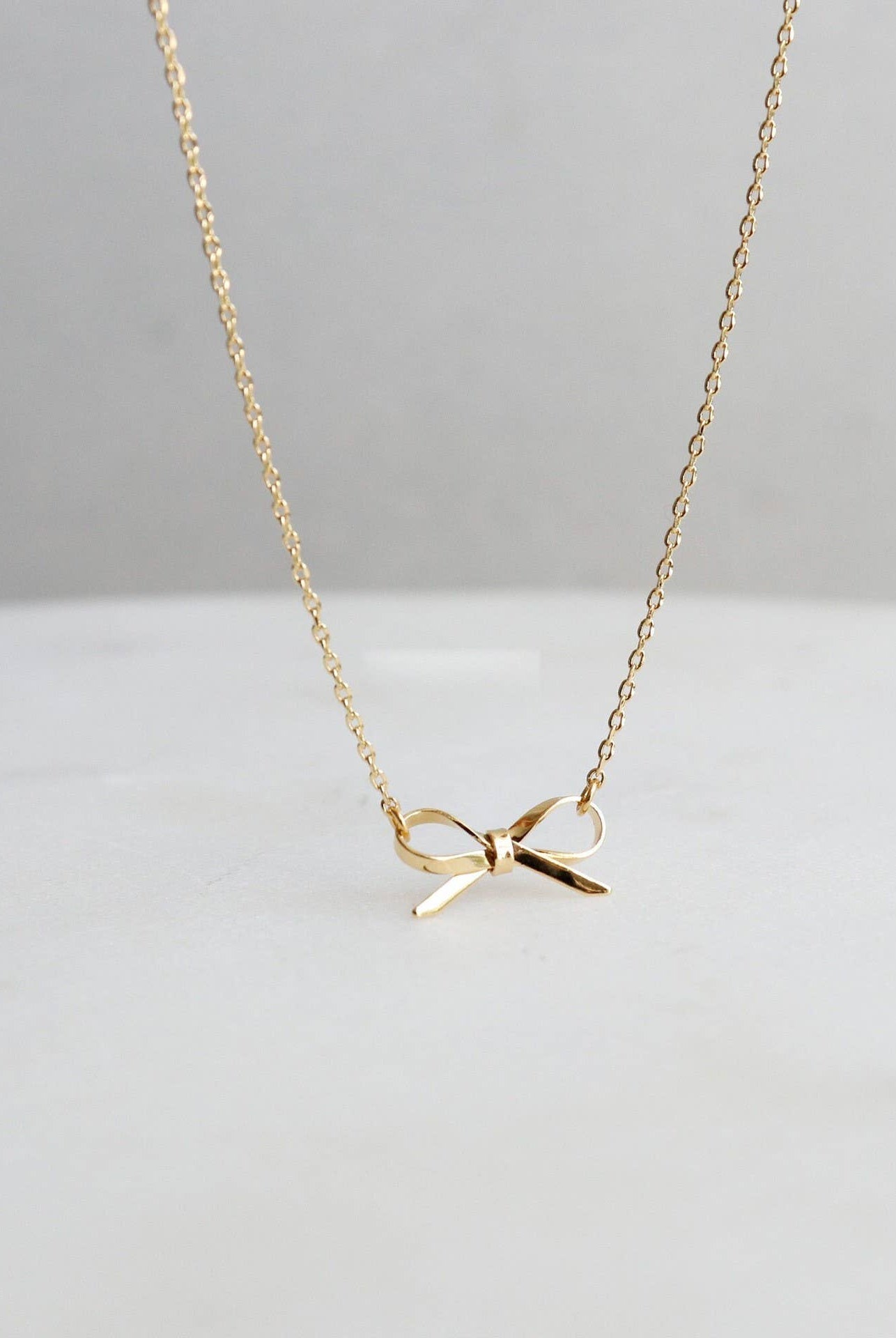 Gold Bow Necklace { product_type }}