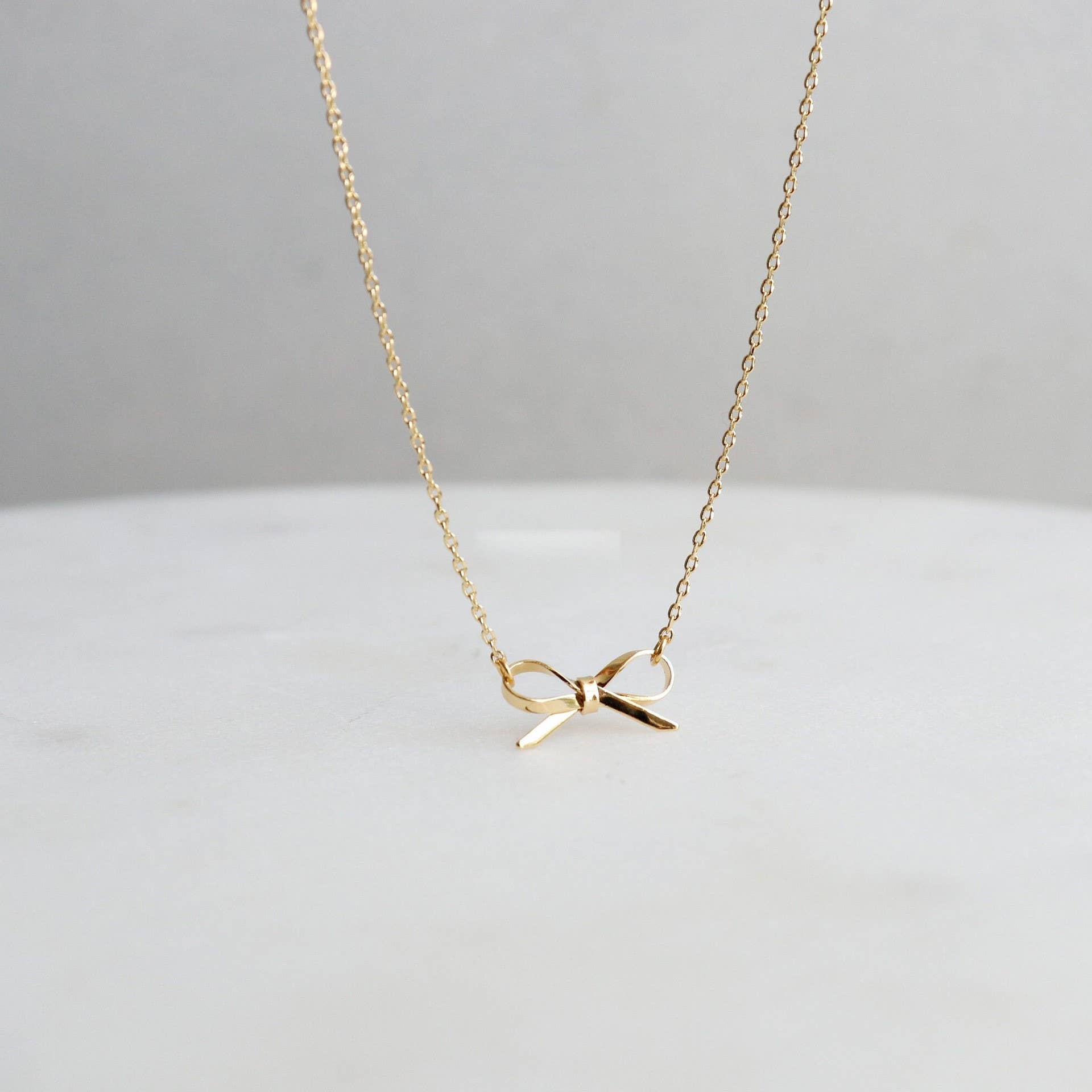 Gold Bow Necklace { product_type }}